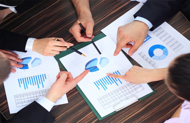 hand pointing at business document during discussion at meeting