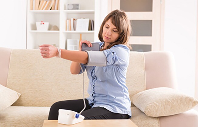 woman checking her blood pressure